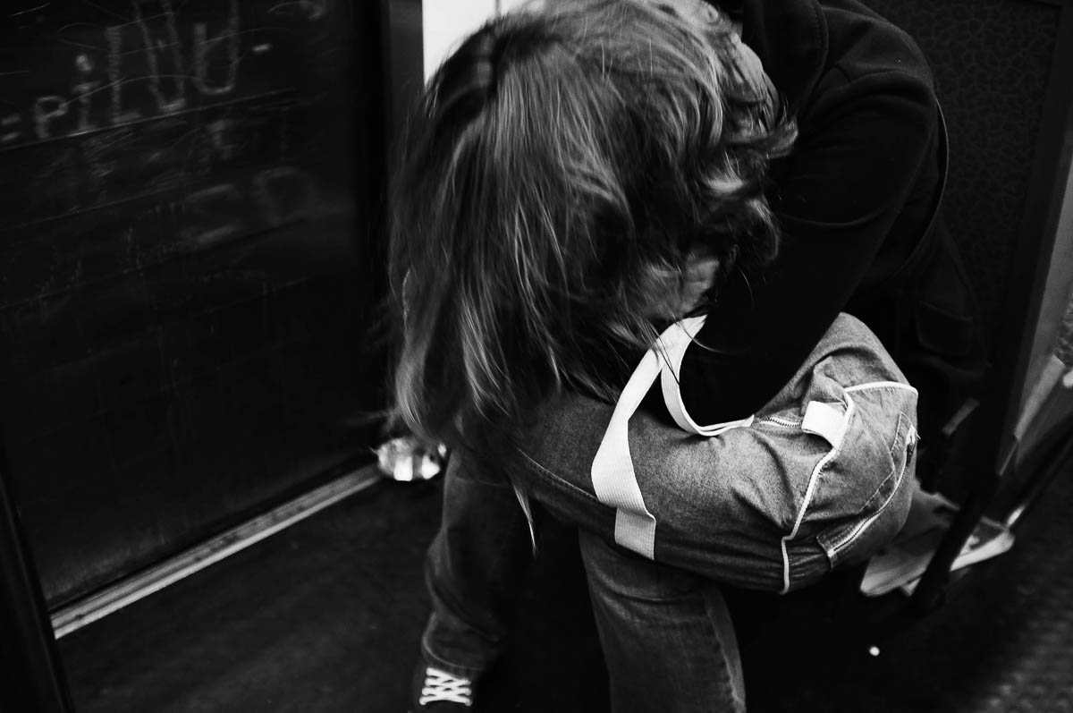 A young woman sitting on the Paris metro fell asleep on her bag, which was resting on her lap, from the series Going Underground by Emmanuel Pineau